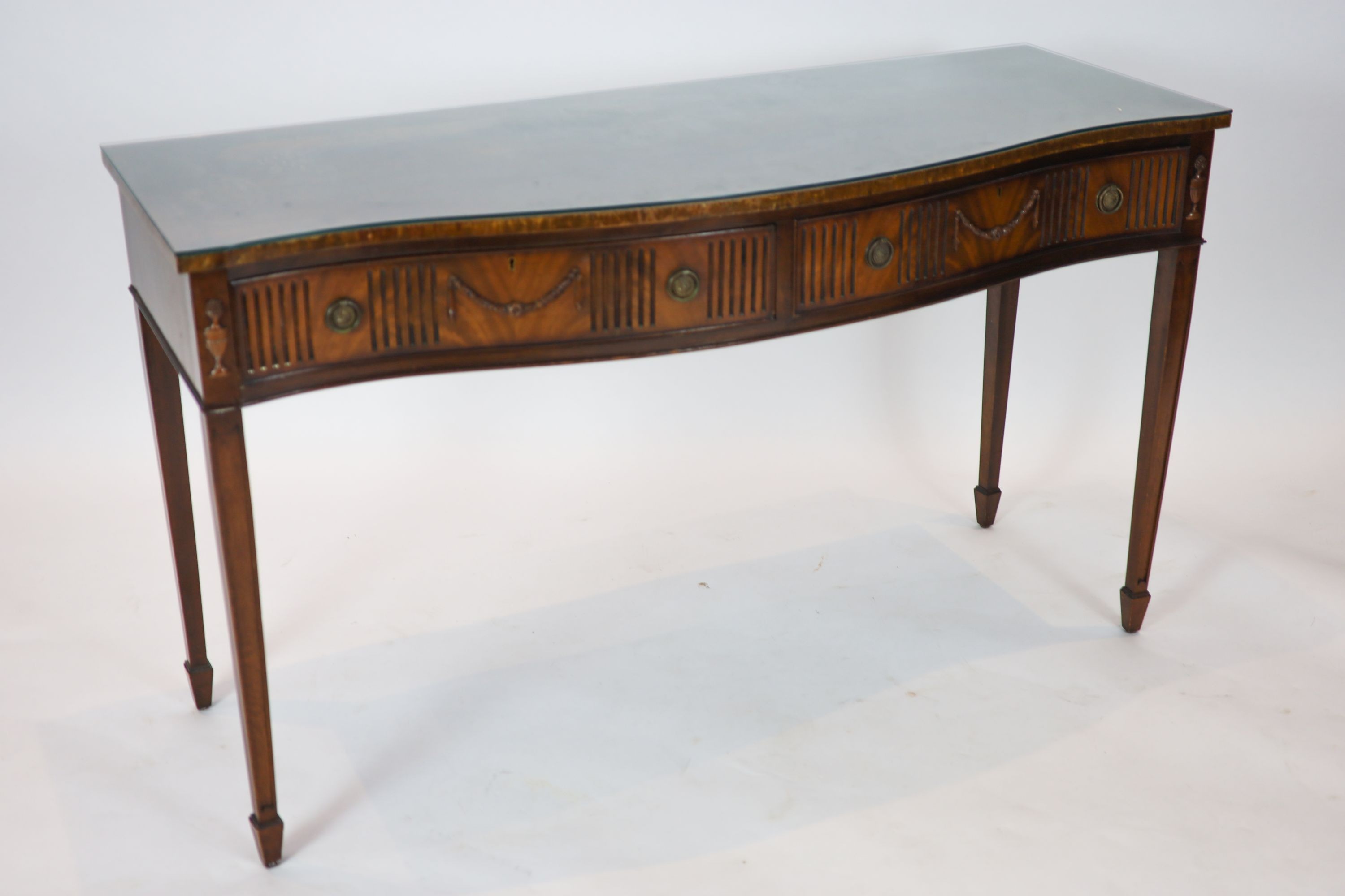 A George III style mahogany serpentine fronted serving table, width 153cm, depth 57cm height 88cm